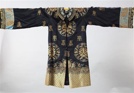 A Chinese black silk and gilt couch work shou robe, early 20th century, length 90cm